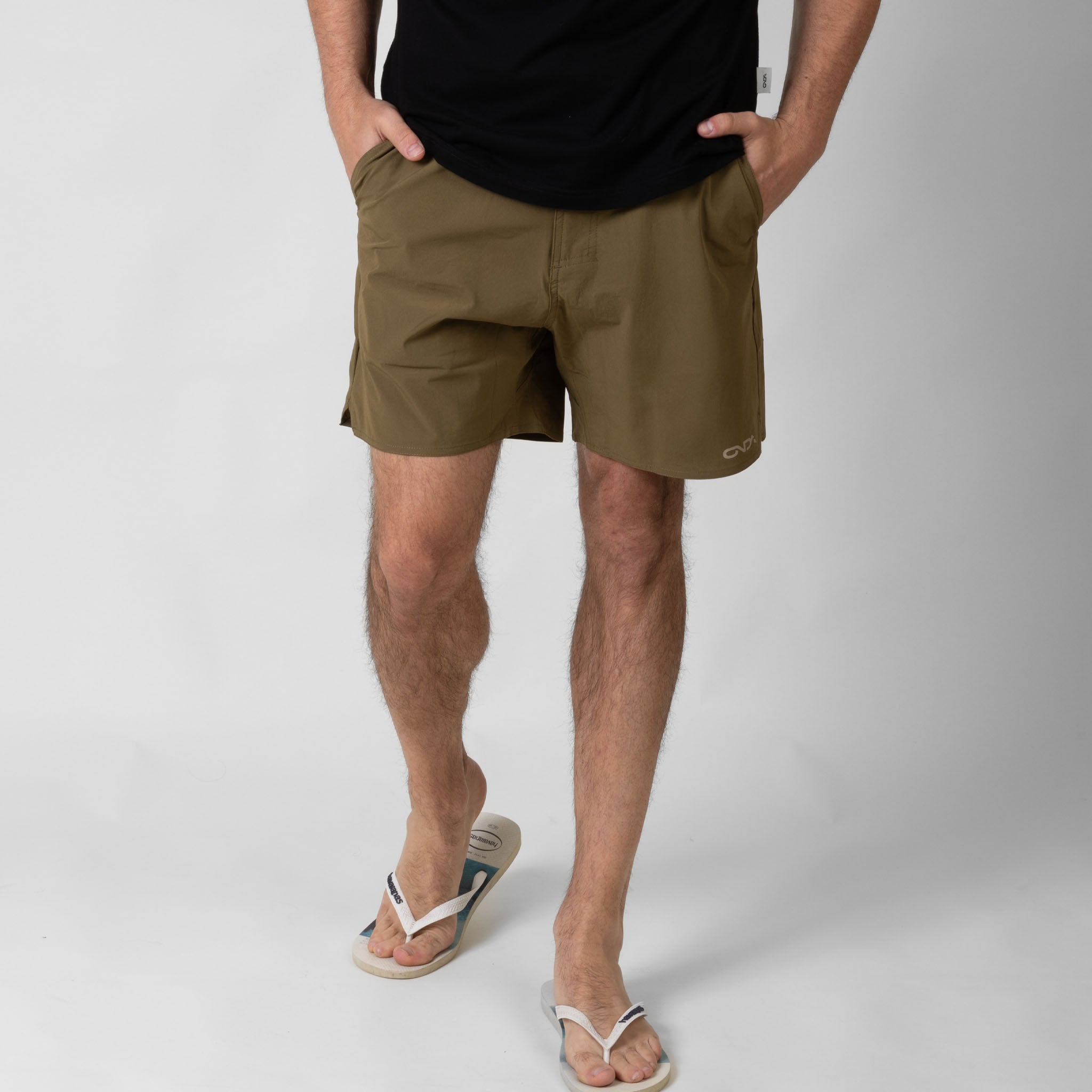 Person wearing brown shorts on a white background