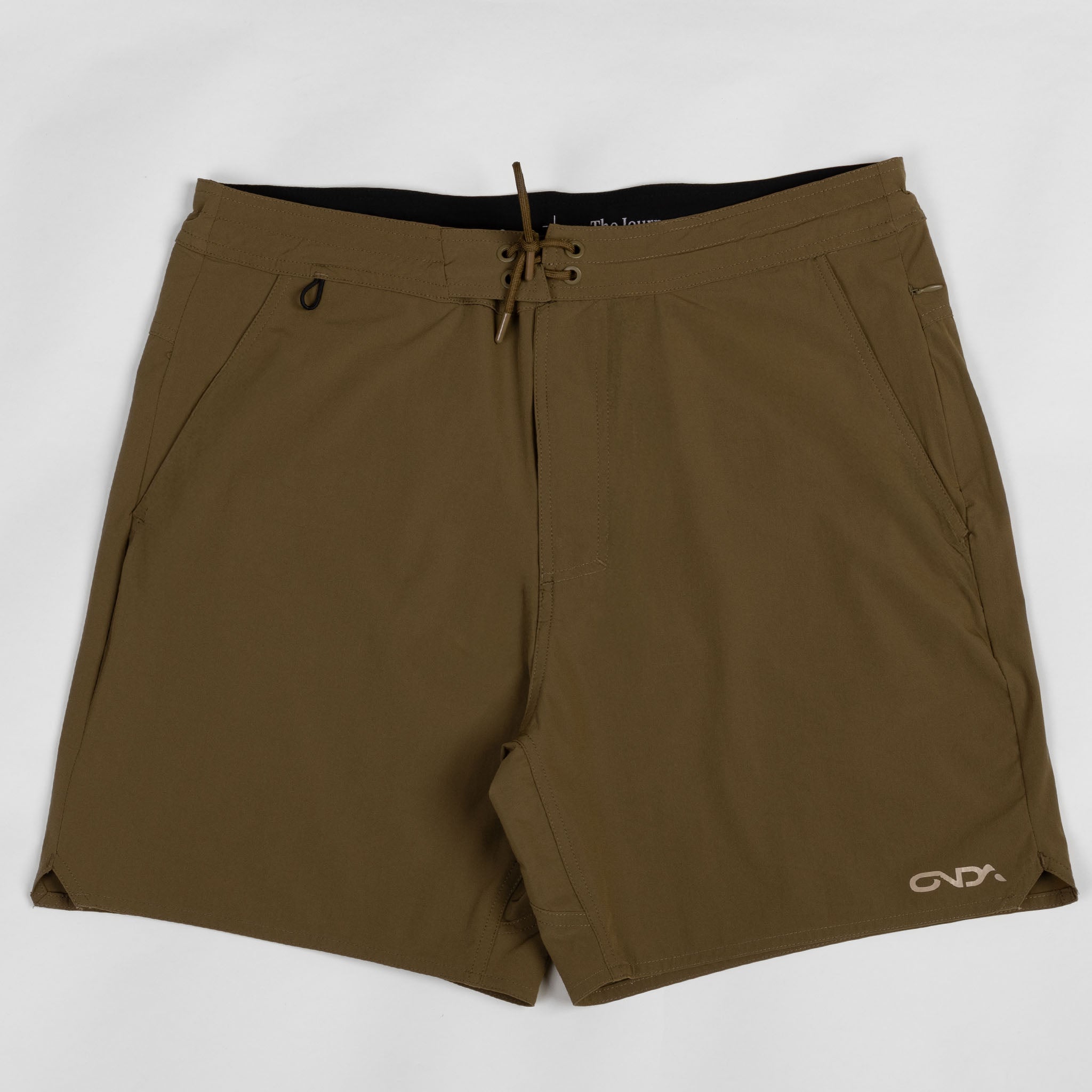 Brown shorts with an onda logo on a white background