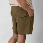 Person wearing brown cargo shorts on a white background