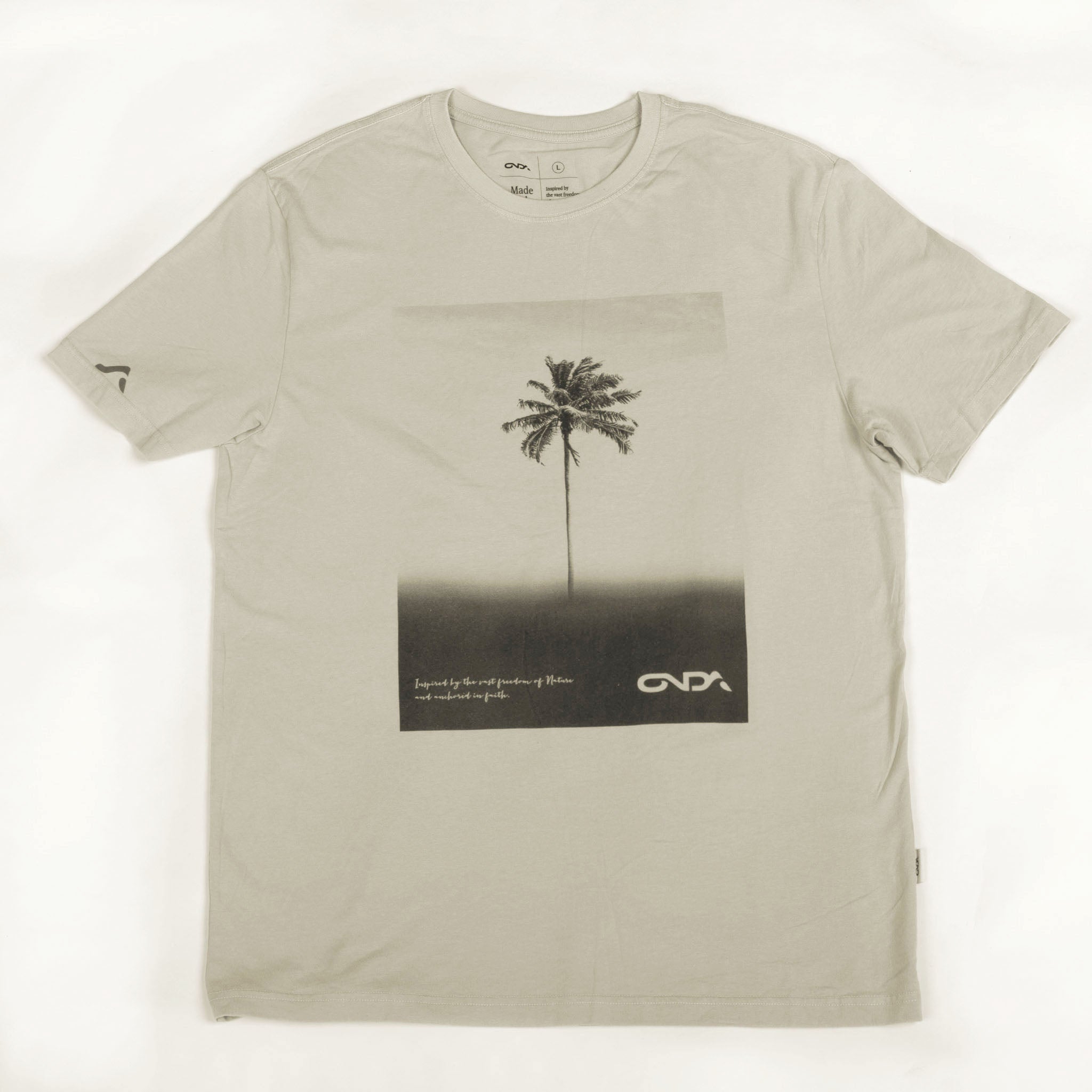 Beige t-shirt with palm tree graphic and onda logo on a white background