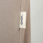 Close-up of a beige fabric with a onda label on a white background