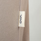 Close-up of a beige fabric with a onda label on a white background